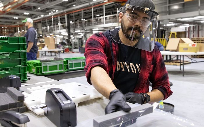 Jose Martinez, assembles protective face shields for health-care workers at the John Deere Seeding factory in Moline, Ill.