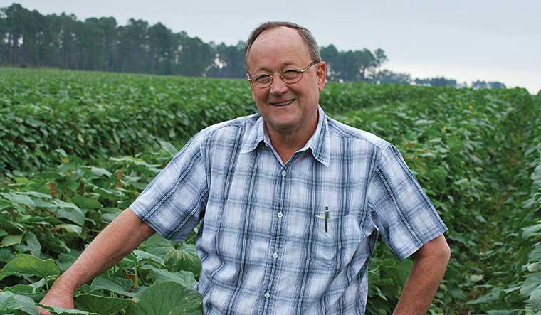 Bill Brim, co-owner of Lewis Taylor Farms in Tifton, Georgia, uses technology to reduce the labor needs of his transplant and vegetable farming operation, which includes this field of cucumbers.